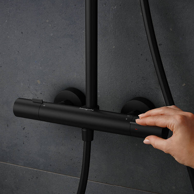 Adjusting the water temperature on the Thermostat of the Hansgrohe Pulsify S Puro Shower Set, in matt black finish, supplied by Deluxe Bathrooms.