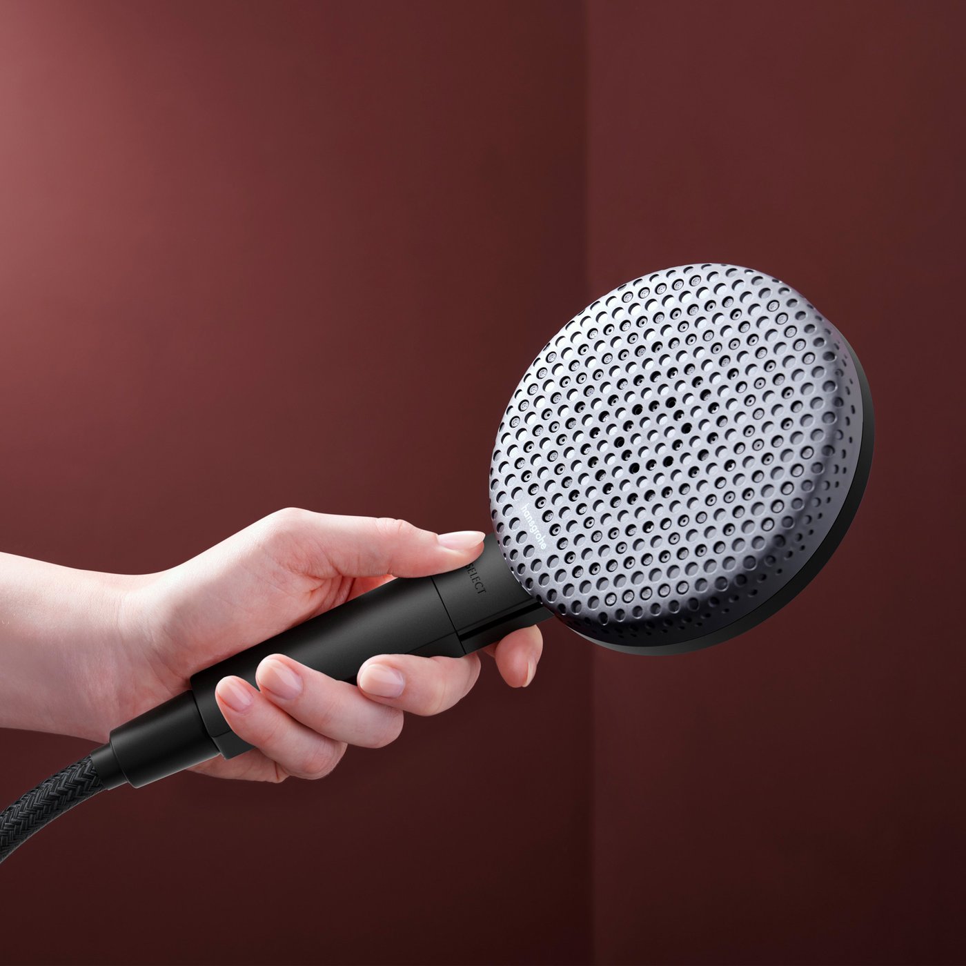 Close up view of the matt black shower head from the Hansgrohe Raindance Alive shower system, supplied by Deluxe Bathrooms.