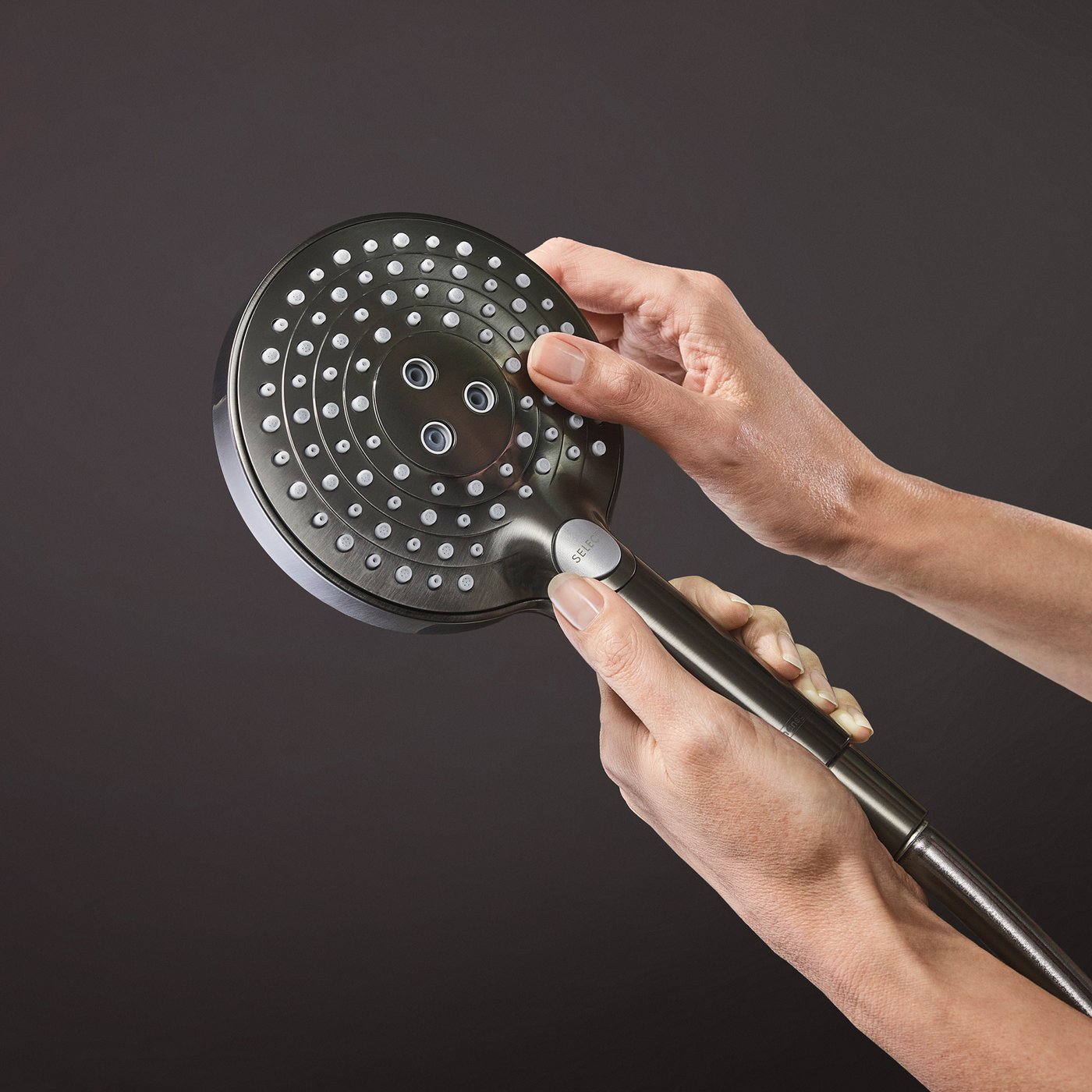 Handset shower water jet selection button on a Hansgrohe Shower supplied by Deluxe Bathrooms.