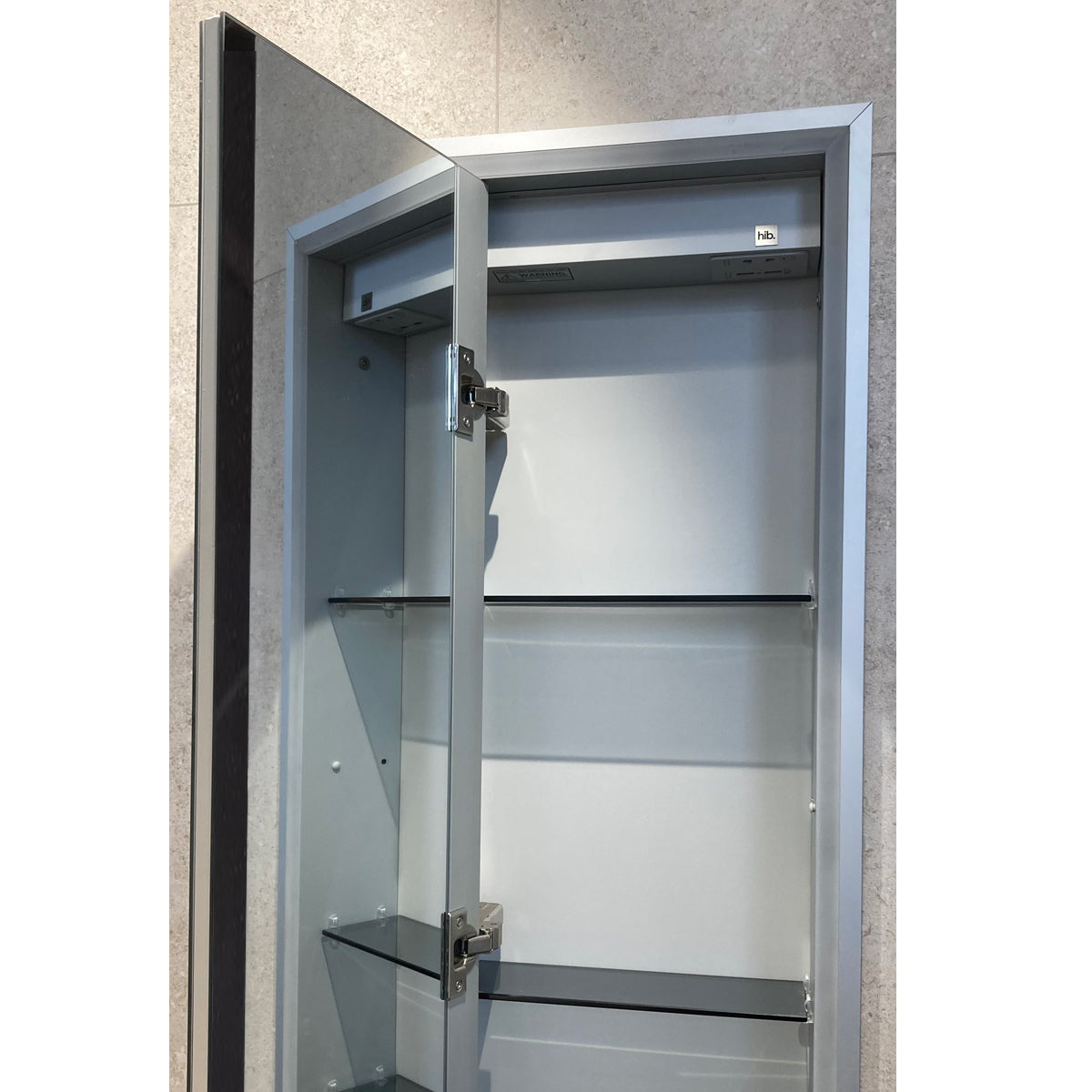 Hib Vanquish 30 Wall Mounted Recessed Cabinet with door open showing internal mirror, shelving and integrated charging sockets.