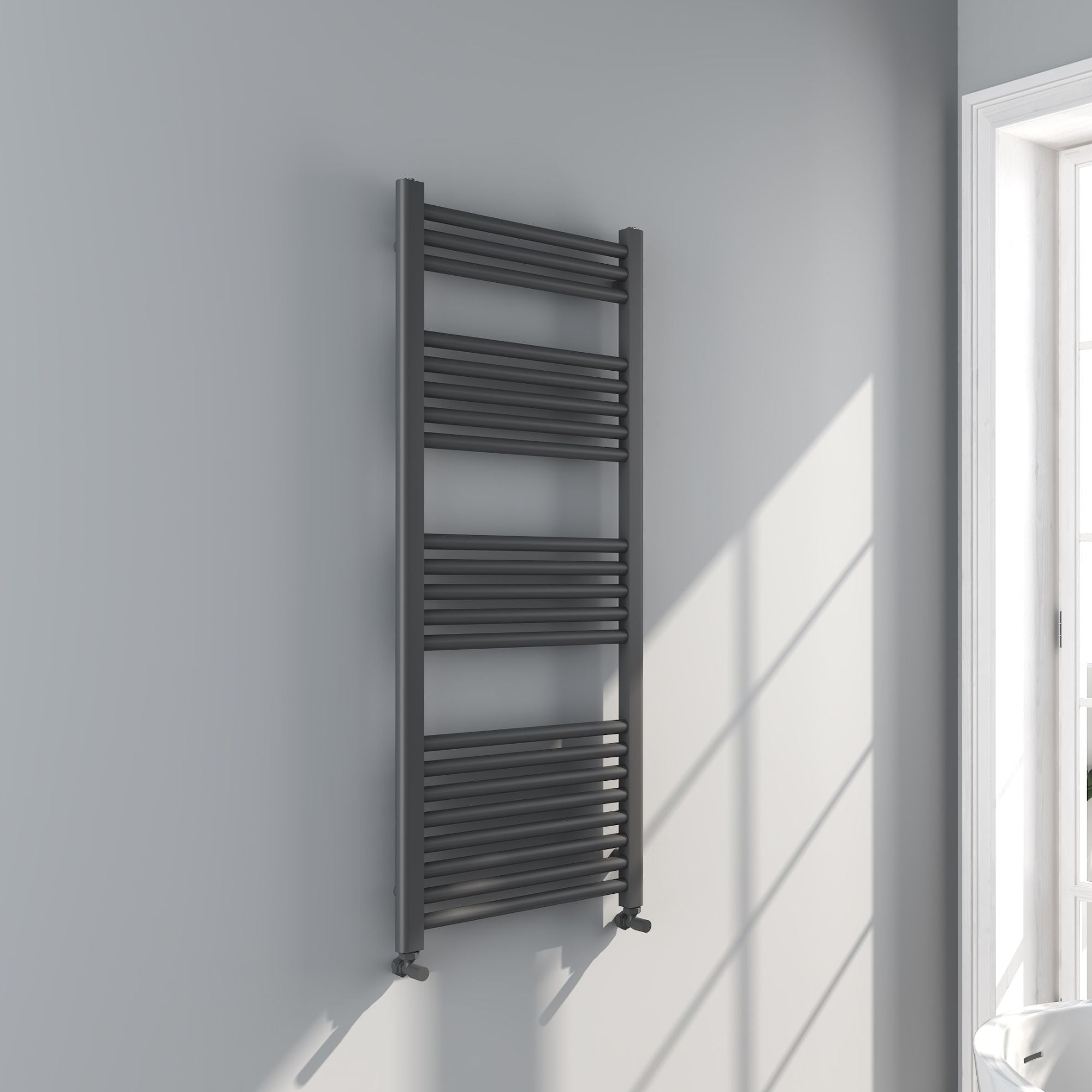 Soho gunmetal towel radiator 1200x500mm on a white wall with a window in the background deluxe bathrooms