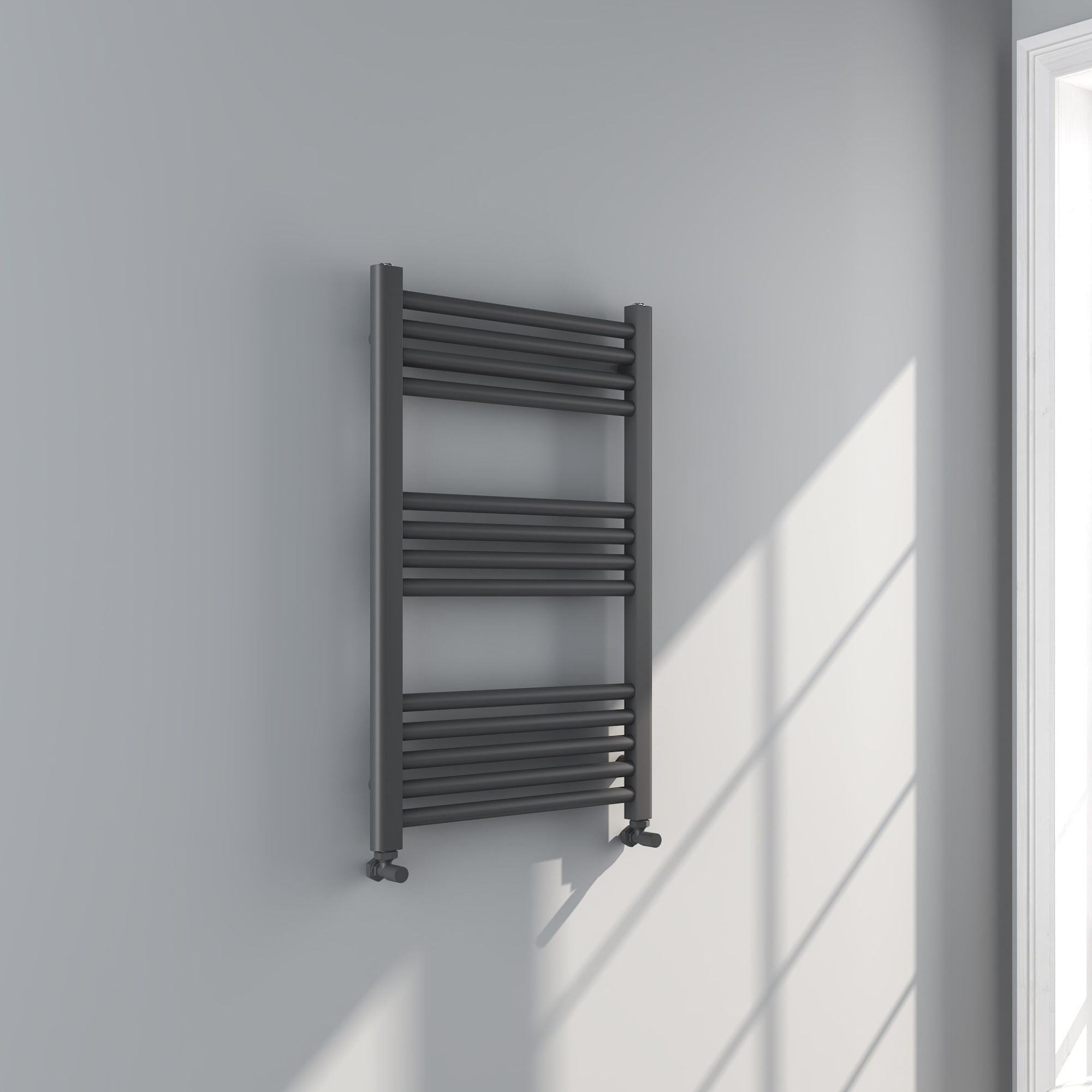Soho gunmetal towel radiator 800x500mm on a white wall with a window in the background deluxe bathrooms