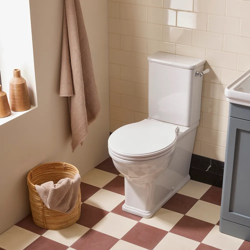 Tavistock Marston fully enclosed toilet with chrome lever in a bathroom. Toilet supplied by Deluxe Bathrooms.