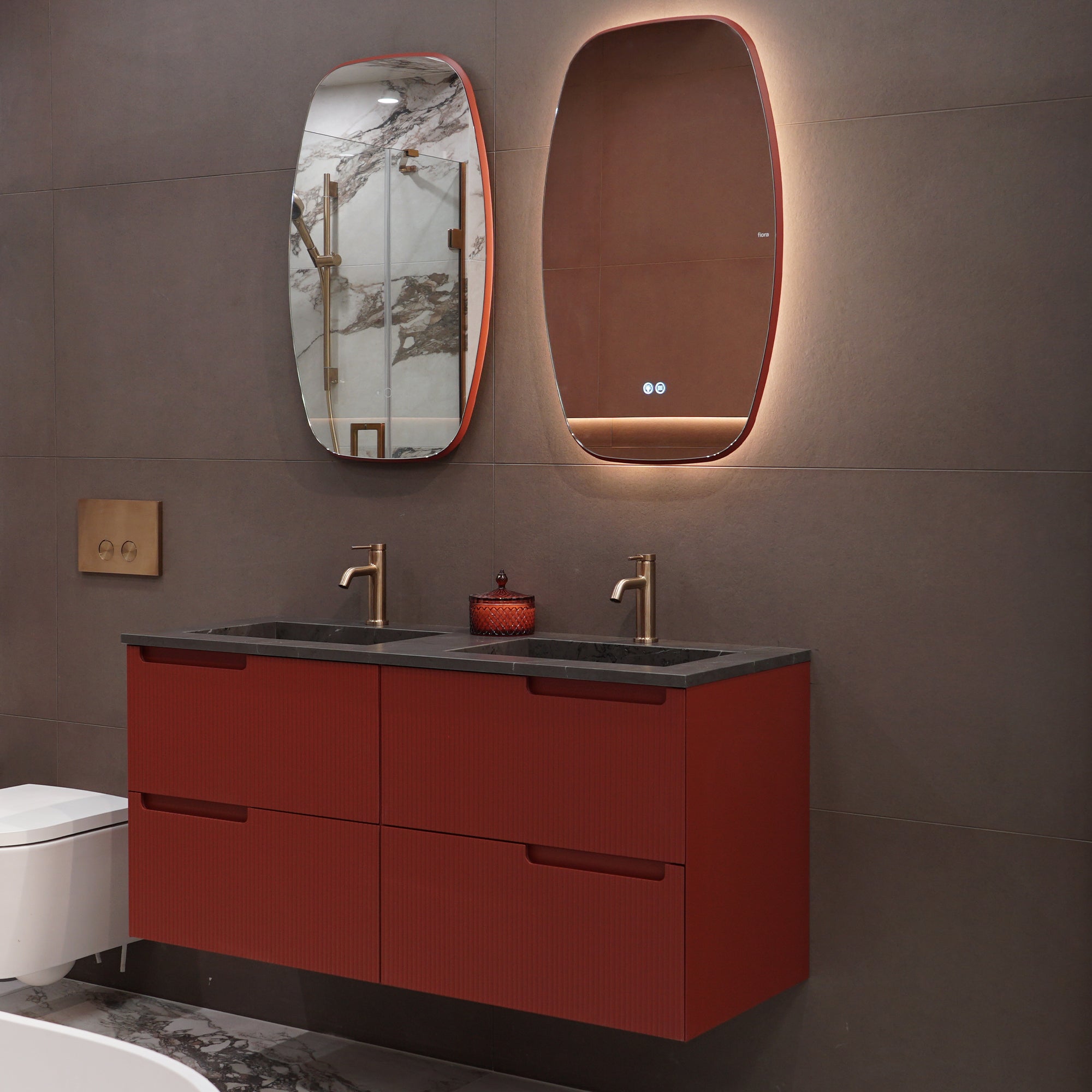 Bathroom vanity with red cabinets, black countertop, and Fiora Shape LED Illuminated Bathroom Mirror