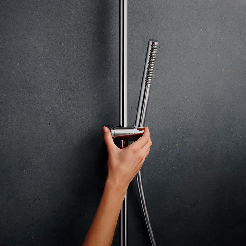 Height adjustment of handset shower in a Hansgrohe Pulsify S Puro shower system, in a chrome finish, supplied by Deluxe Bathrooms.
