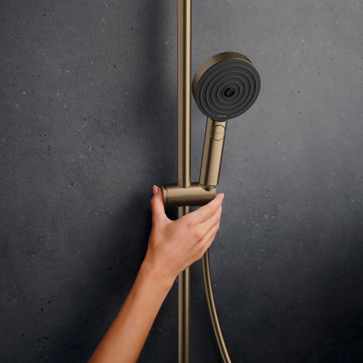 Adjustable handset height of the Hansgrohe Pulsify S Puro Shower Set, in brushed bronze, supplied by Deluxe Bathrooms.