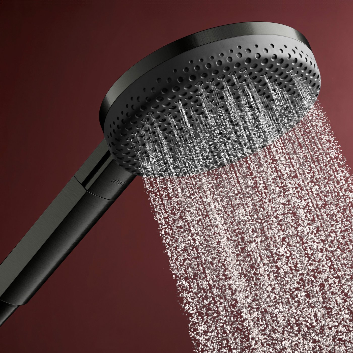 Water jet flow from the brushed black chrome shower head of the Hansgrohe Raindance Alive shower system, supplied by Deluxe Bathrooms.