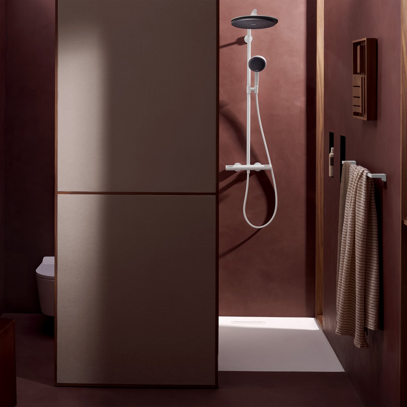 Lifestyle bathroom view of the Hansgrohe Raindance Alive shower system, in matt white, supplied by Deluxe Bathrooms.