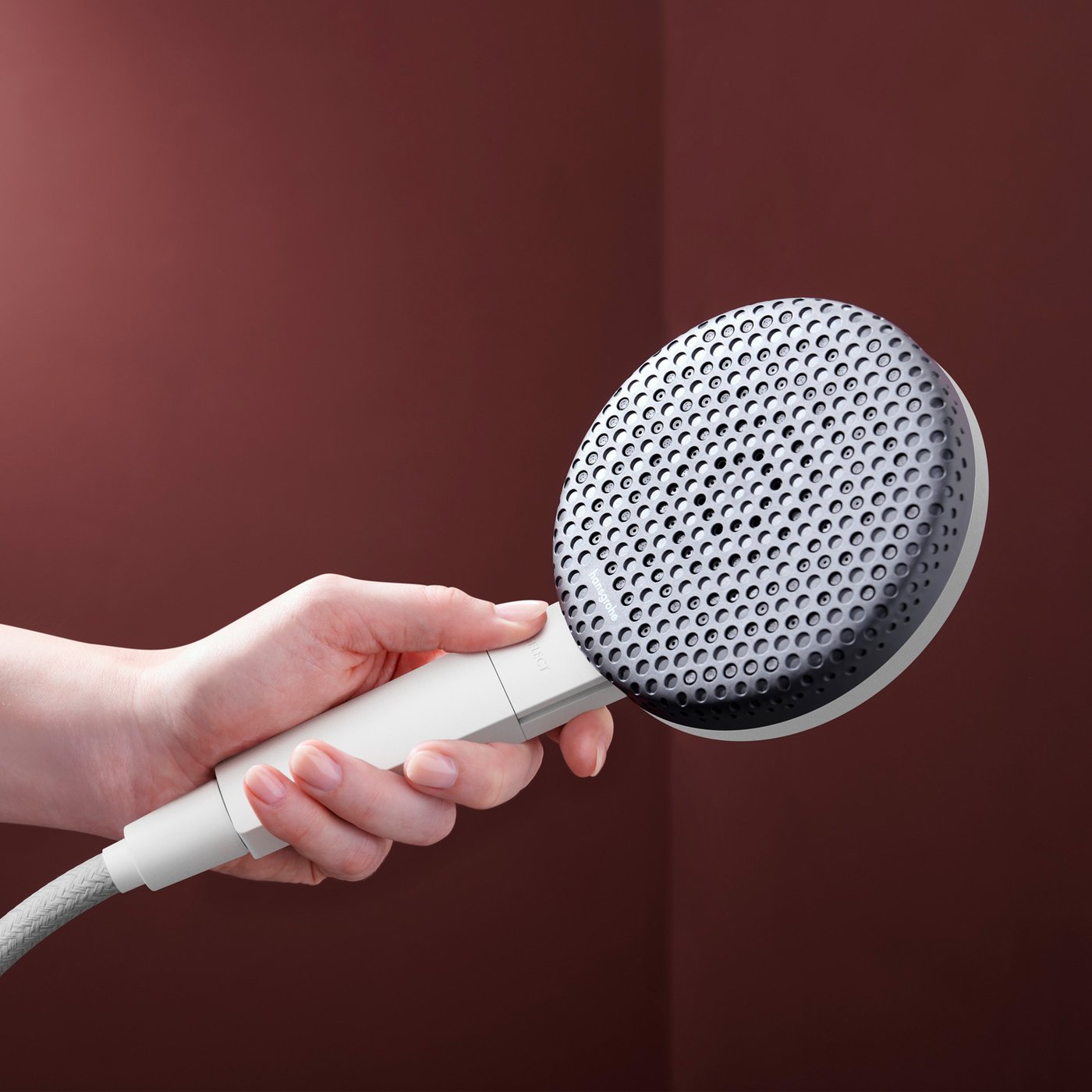 Close up view of the matt white shower head from the Hansgrohe Raindance Alive shower system, supplied by Deluxe Bathrooms.