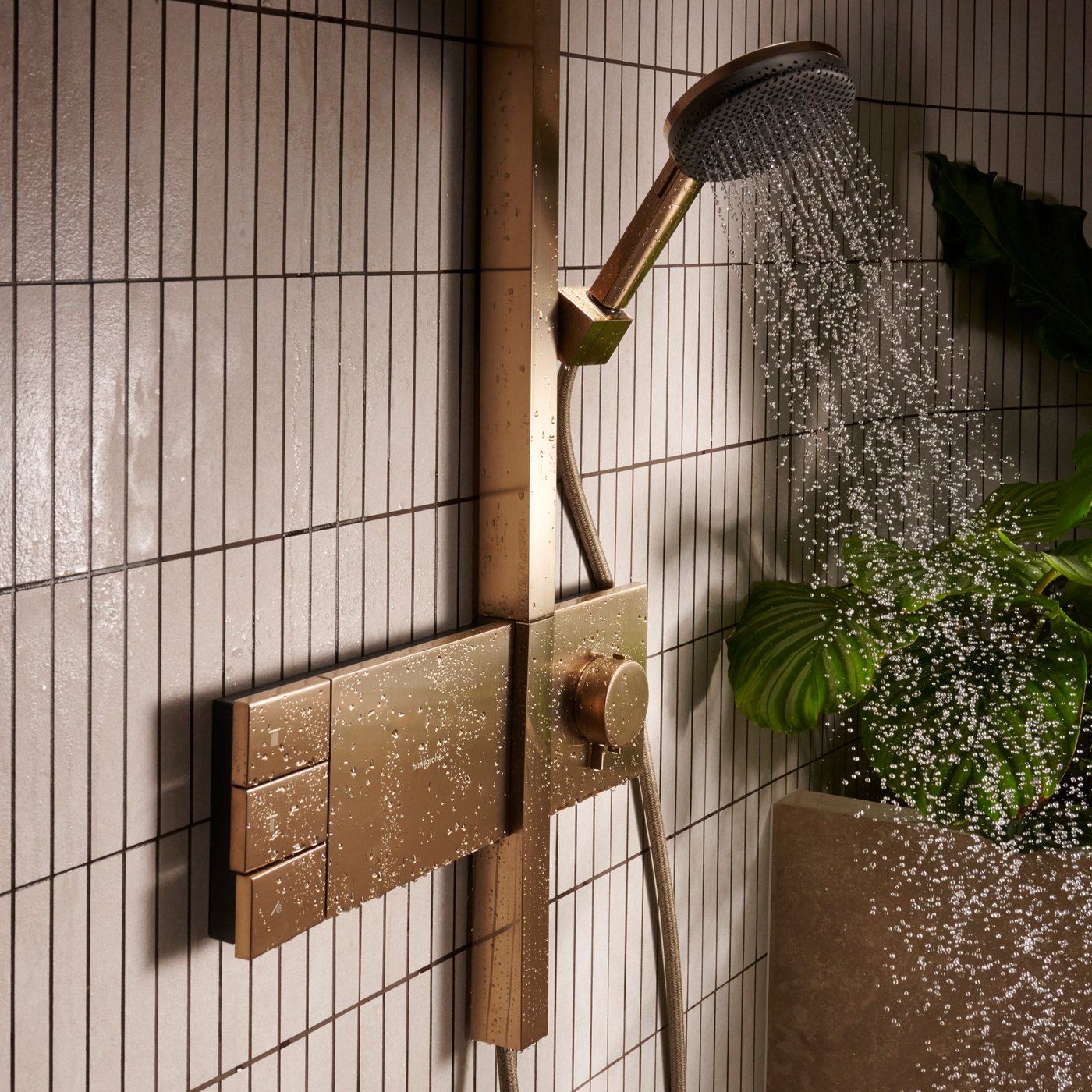Water flowing from the handset of the Hansgrohe Raindance Alive S Shower system, supplied by Deluxe Bathrooms.
