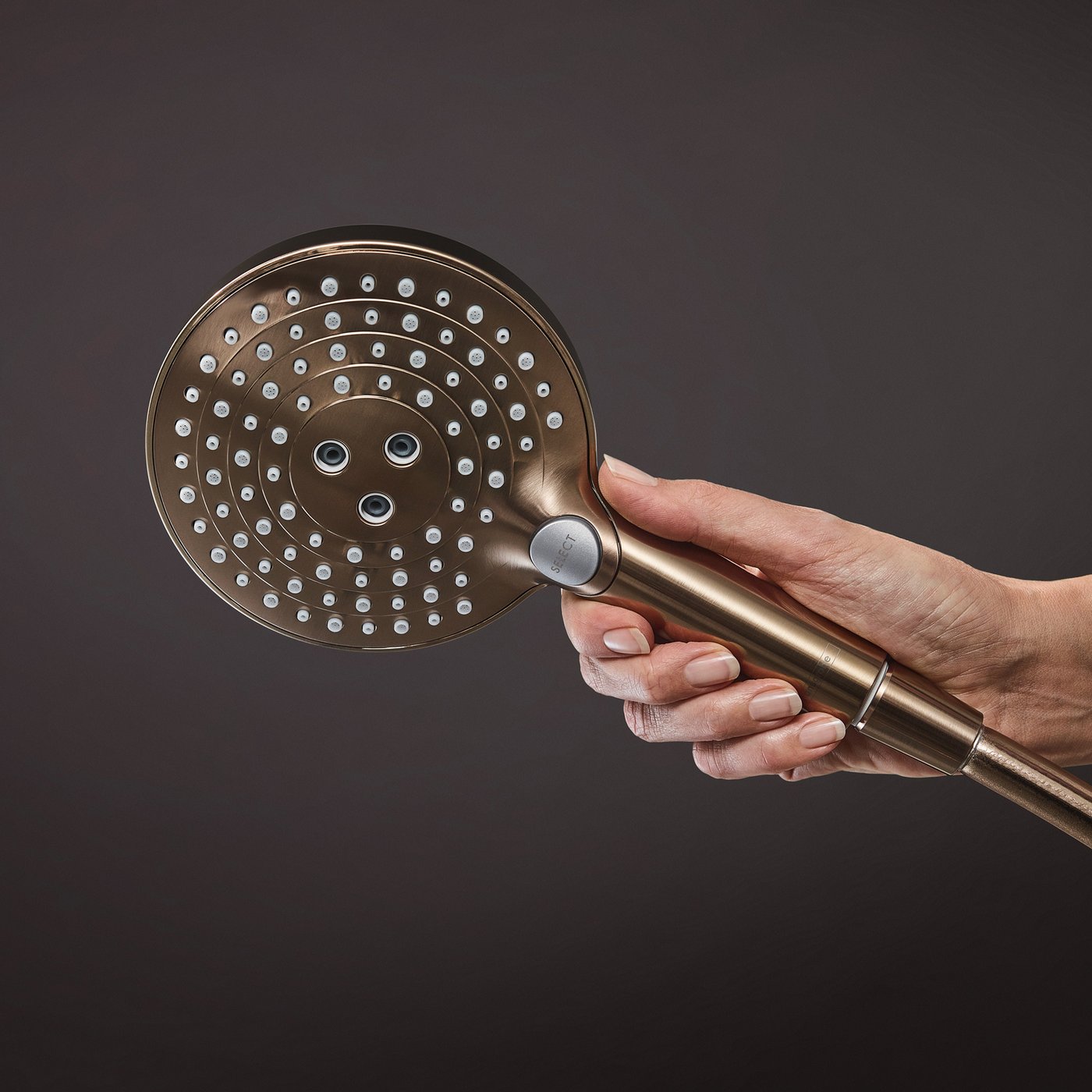 Close up view of the handset in brushed bronze from the Hansgrohe Raindance Select 1-Jet Shower system. Supplied by Deluxe Bathrooms.
