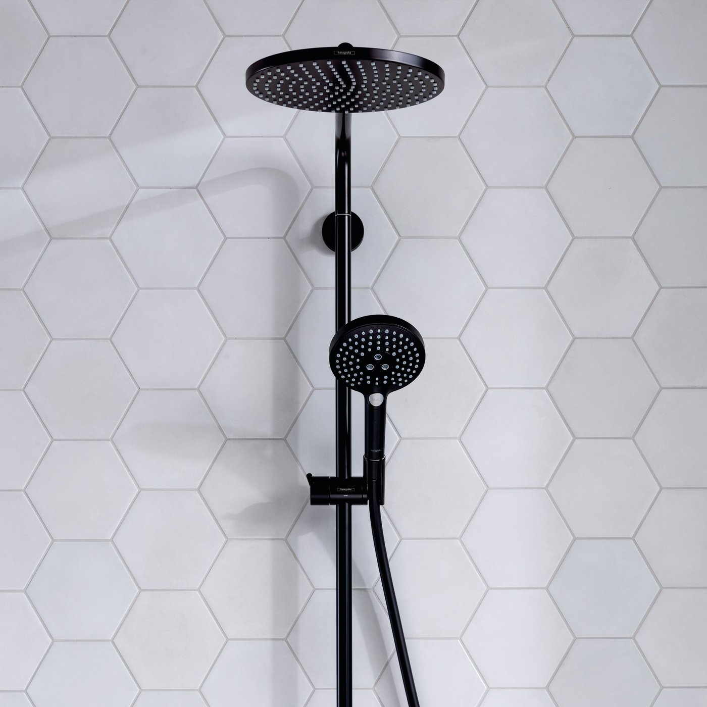 Close up view of the Hansgrohe Raindance Select 1-Jet Shower with 240mm Head - in matt black finish - installed in a bathroom. Supplied by Deluxe Bathrooms.