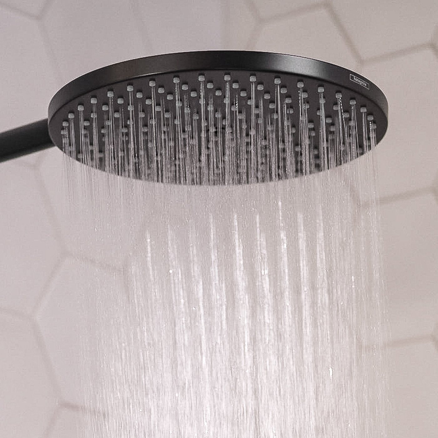 Close up of water droplets coming from shower head of a Hansgrohe shower system, supplied by Deluxe Bathrooms.