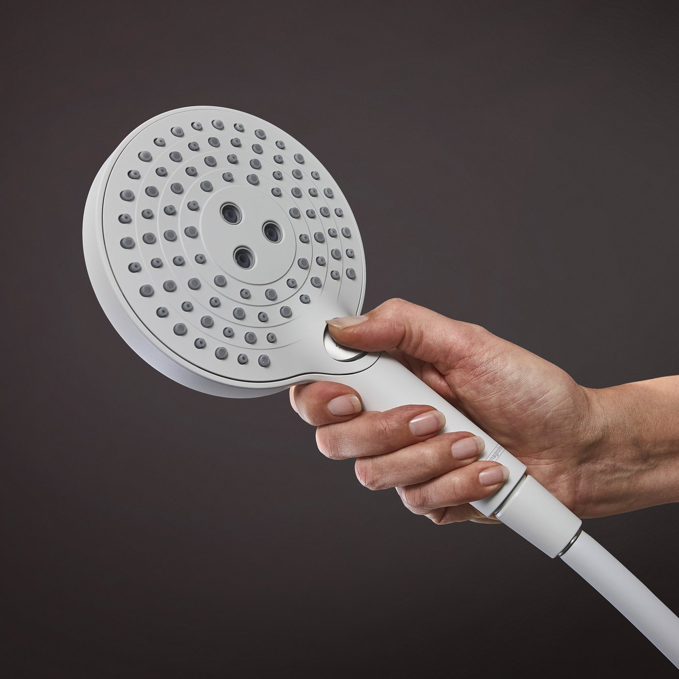 Person selecting a spray type on a  Hansgrohe shower handset, supplied by Deluxe Bathrooms.