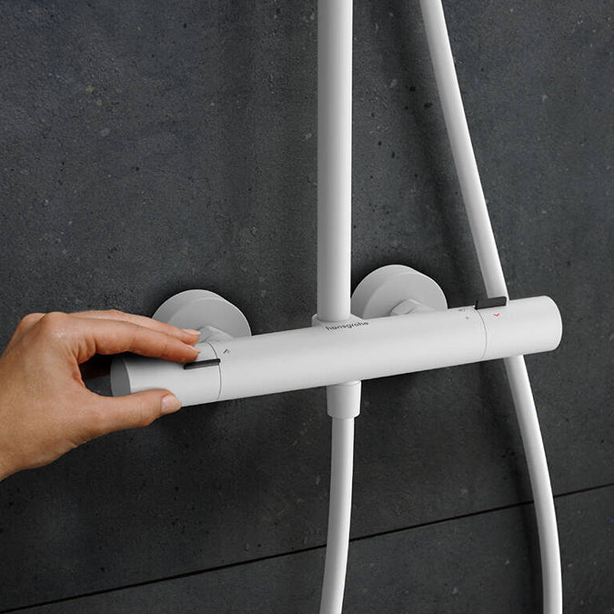 User operating the Thermostat of the Hansgrohe Pulsify S Puro Shower Set, in Matt White, supplied by Deluxe Bathrooms.