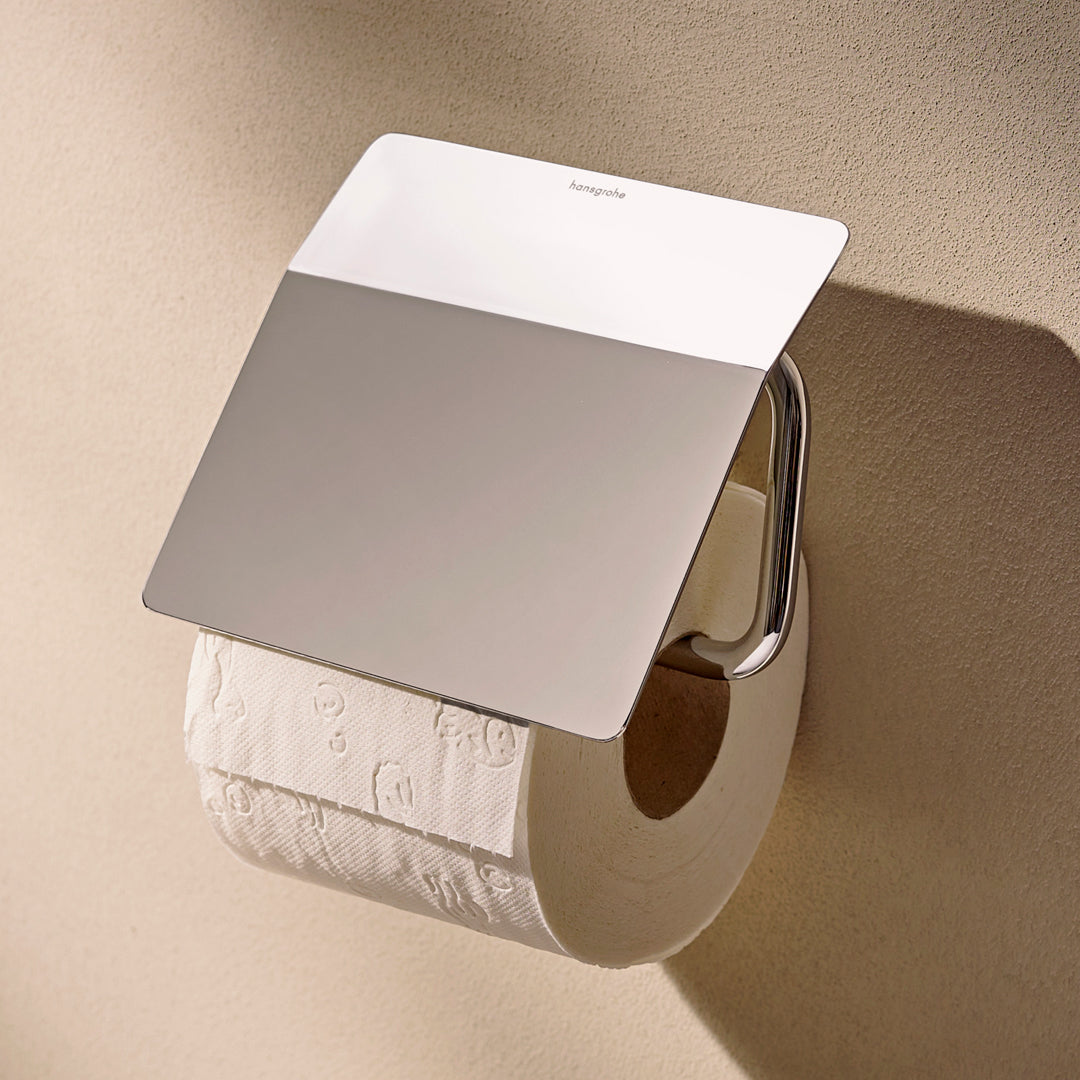 Photo of  the Hansgrohe AddStoris S Toilet Roll Holder with Cover in chrome finish, with a toilet roll in place.