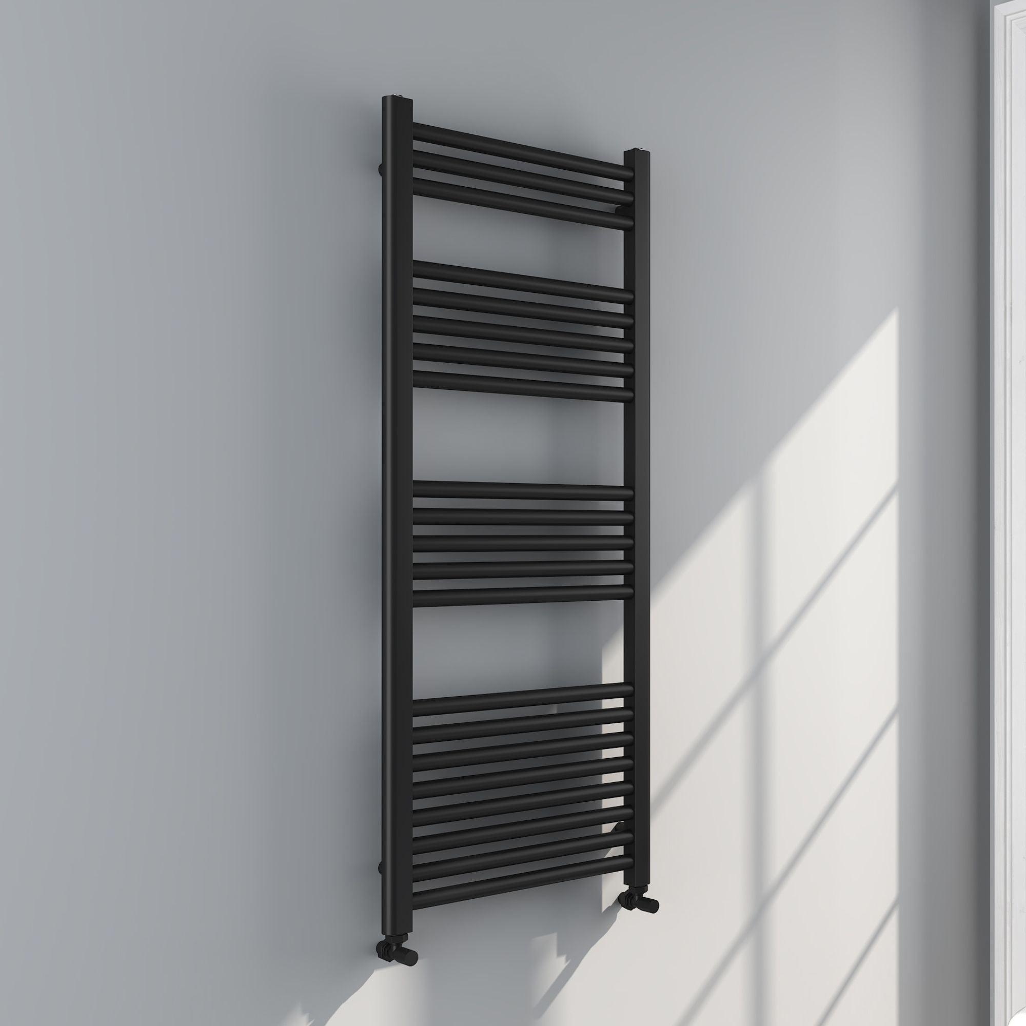 Soho matt black towel radiator on a white wall with sunlight casting shadows deluxe bathrooms